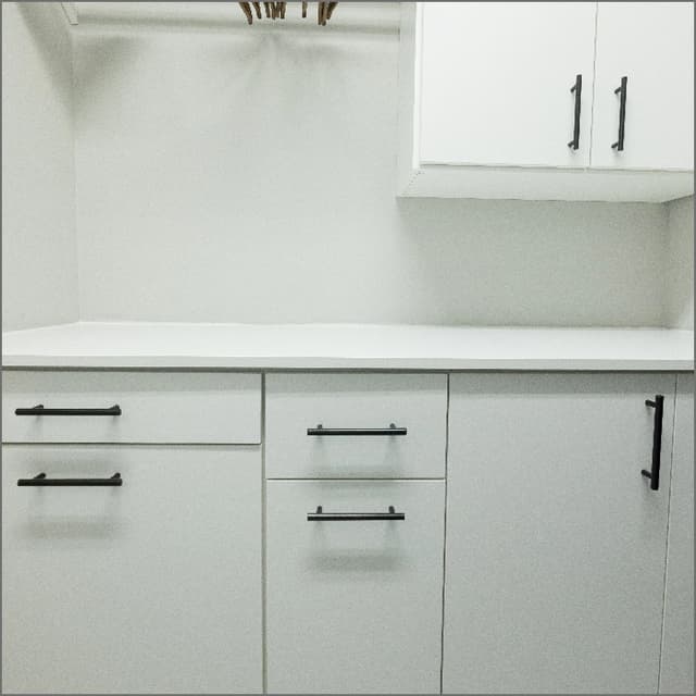 white counters with stainless steel appliance